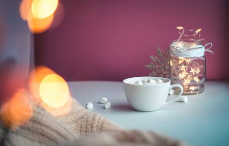 Cold autumn or winter setup. Warm cocoa with marshmellows. Cosy scene, hygge concept, top veiw. Pastel colors. Christmas is coming.の写真素材