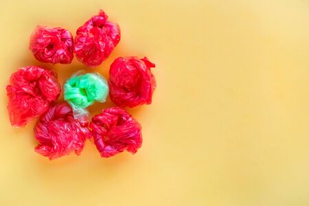 Flower made of rolled colorful plastic bags. Recycling and waste reducing concept. Top view.の写真素材