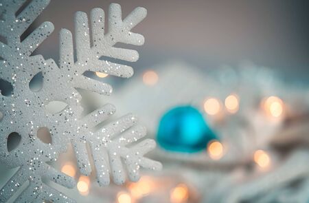 White and blue holiday decorations on silver background. Christmas balls, candle and fairy lights.Color of the year concept.の写真素材