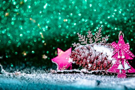 Red Christmas decorations pattern on green background.の写真素材