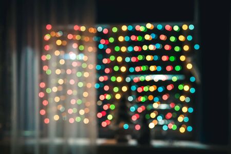 Blurred holiday psychedelic defocused lights yellow, green, red background. String lights, Celebration, new year or christmas concept.の写真素材