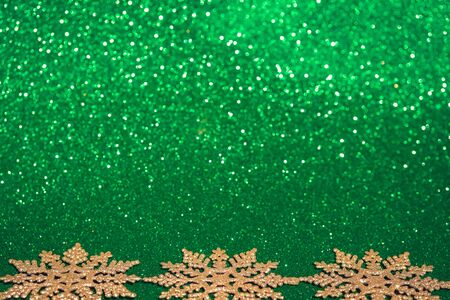 Defocused golden Christmas decorations on chive green background.の写真素材