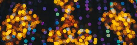 Blue and yellow blurred fairy lights, holiday concept. Web banner.の写真素材