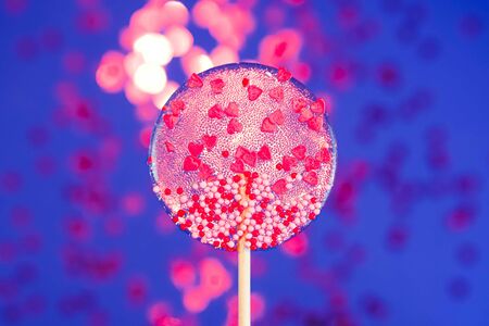 Happy Valentines Day Background with candy red hearts lollipops on dark blue background.の写真素材