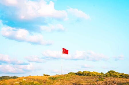 National flag of Turkey on top of the hill against the clear blue sky at the suburbs of Istanbul.の写真素材