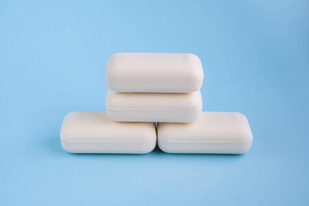 Bars of white soap on light blue background. Wash your hands concept. Stop bacteria or infection.の写真素材