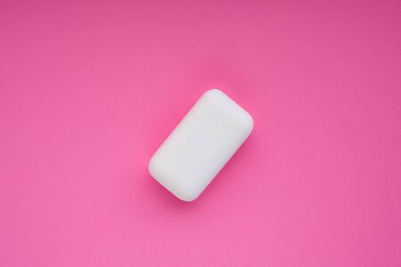 Bar of white soap on pink magenta background. Wash your hends concept.の写真素材