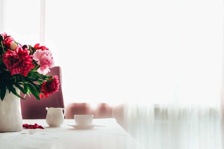 Morning coffee with flowers, spiral notebook and some feminine accessories. Modern woman's morning...