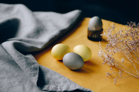 Organic naturally dyed yellow and gray Easter eggs. Stylish holiday decor.の写真素材