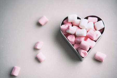 Heart shaped pink sweet marshmallow Valentines day card on gray backgroundの写真素材