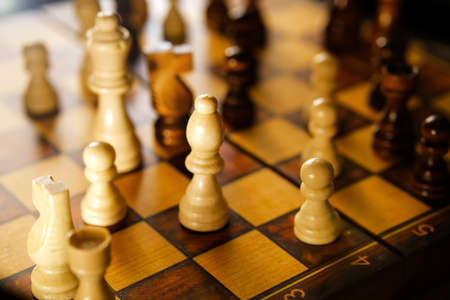 White and brown wooden chess pieces on board game.の写真素材