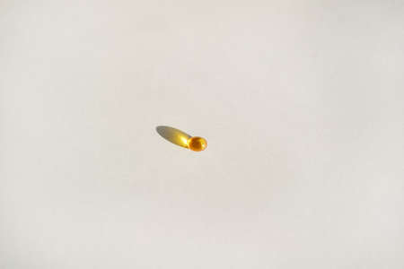 Yellow gel transparent gel capsules of vitamin d or omega 3 in spoon.の写真素材