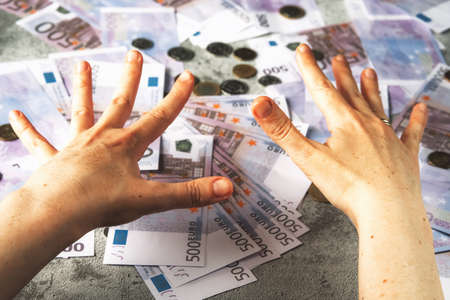 Several five hundred euro banknotes in womans hand. Money concept.