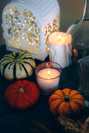 Cozy autumn home decor with candles and pumpking.の写真素材