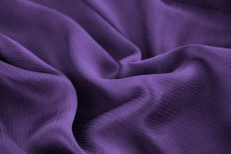 Violet lilac silk fabric background. Color of the year.