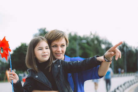 Mother and daughter happy and smiling walking together.の写真素材