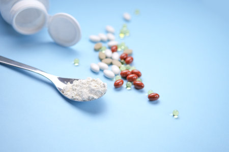 Nutritional supplements, vitamins and nutraceuticals on blue background.