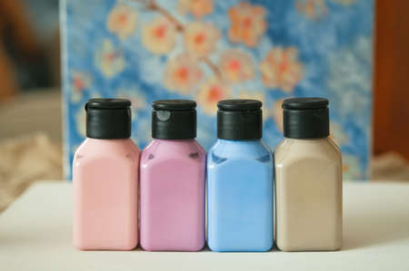 Set of pastel acrilic paint jars in white canvas.の写真素材