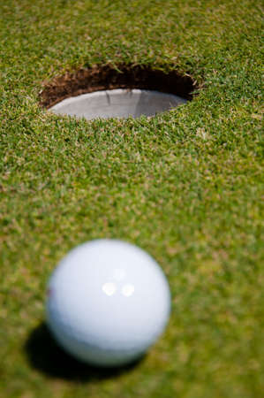 golf hole with ballの写真素材