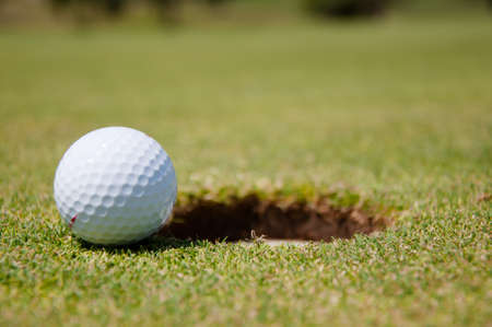 golf hole with ballの写真素材