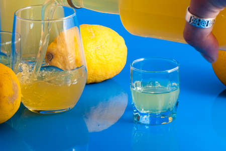 Italian alcoholic drink served in a glass on a light blue backgroundの写真素材