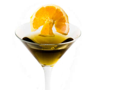 glass of alcoholic drink cocktail with orange slices and cubes on white backgroundの写真素材