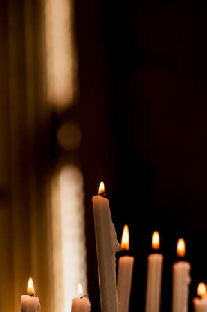 detail of some lit candles in church