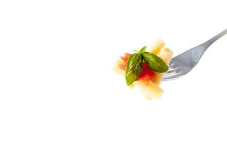 rigatoni pasta with chopped tomatoes, basil, Parmesan cheese and olive oil on a fork