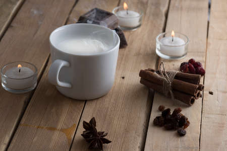 cup of steaming milk on old wooden boardsの写真素材