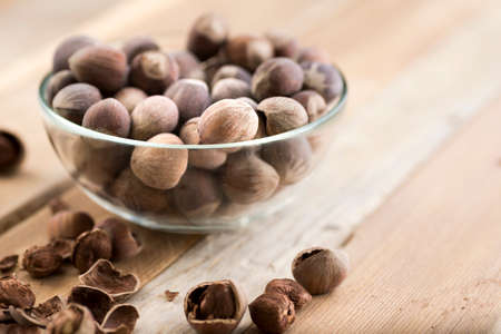 Close-up of hazelnuts on wooden table.の写真素材