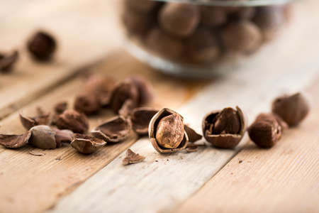 Close-up of hazelnuts on wooden table.