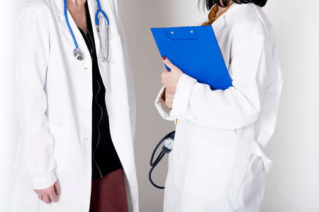photograph of two female doctor who consult a medical chartの写真素材