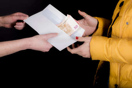 Close up of the exchange of money between two people.