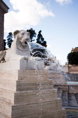 beautiful fountain shaped like a lion in Piazza del Popolo.の写真素材