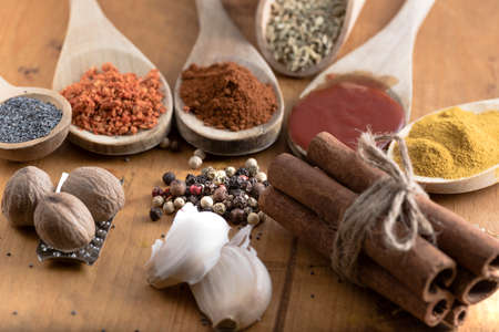 Various colorful spices and food drugs on wooden table