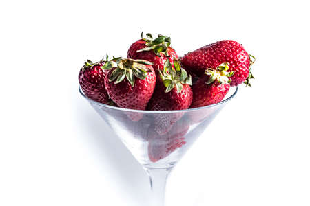 some strawberries in a cocktail glass.