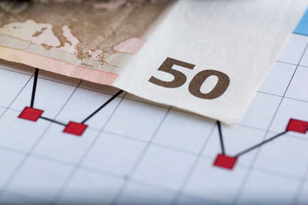 Fifty Euro Banknote in a macro shot, with below chart and sheet accountsの写真素材