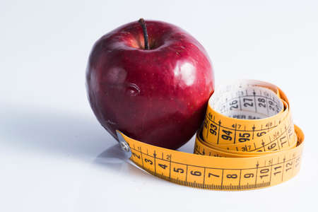 red apple measured the meter on a white background.の写真素材