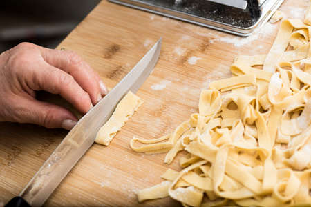 Woman who kneads the homemade pasta to prepare lasagna and tagliatelle.の写真素材