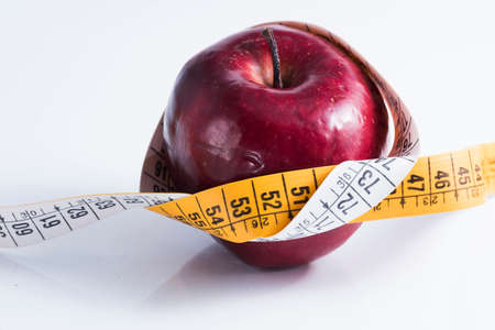 red apple measured the meter on a white background.の写真素材