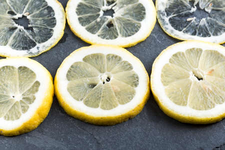 thin slices of lemon on slate.の写真素材