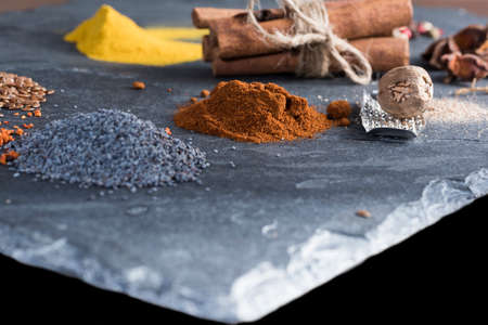 herbs and spices cutlery on dark colored stones.の写真素材