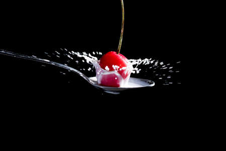 Splash of milk, caused by a fall of a cherry on a spoon