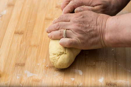 Woman who kneads the homemade pasta to prepare lasagna and tagliatelle.の写真素材