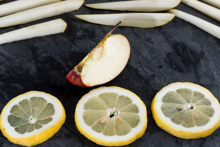sliced fresh fruit served on a slate plate. Food and healthの写真素材