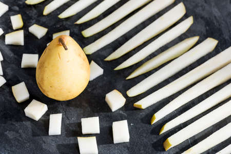 sliced fresh fruit served on a slate plate.の写真素材