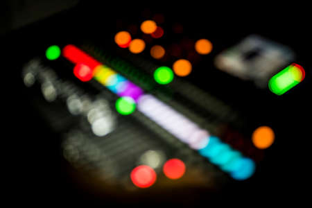 blurred lights of an audio mixer console in a concertの写真素材
