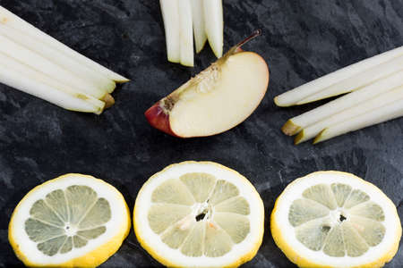 sliced fresh fruit served on a slate plate. Food and healthの写真素材