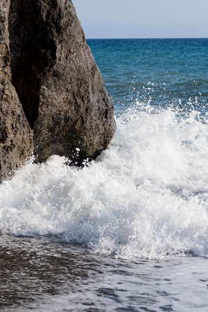 closeup of a rock and blue sea of southern Italyの写真素材