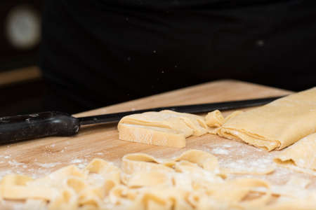preparing homemade pasta for lasagna and tagliatelle, flour, eggs, water and salt.の写真素材